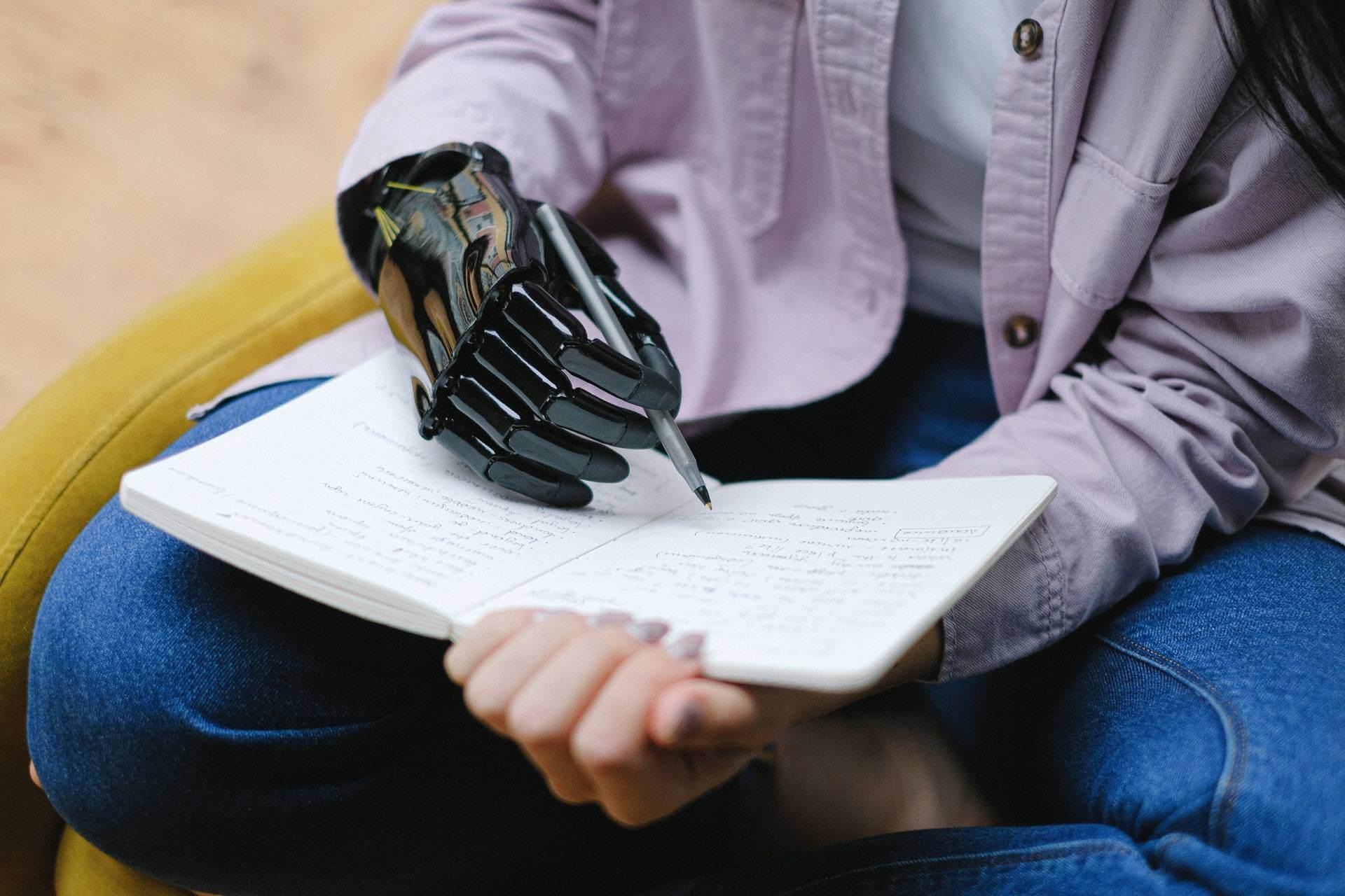 Amputee with prosthetic hand writing