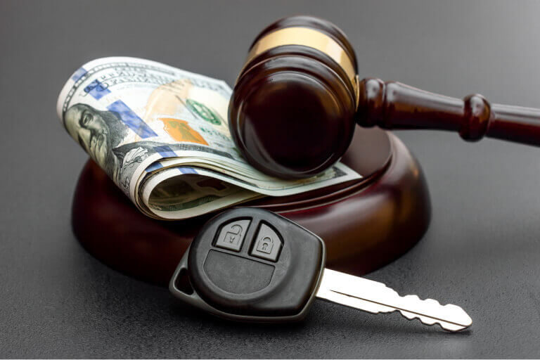 Judge's gavel with car key and money
